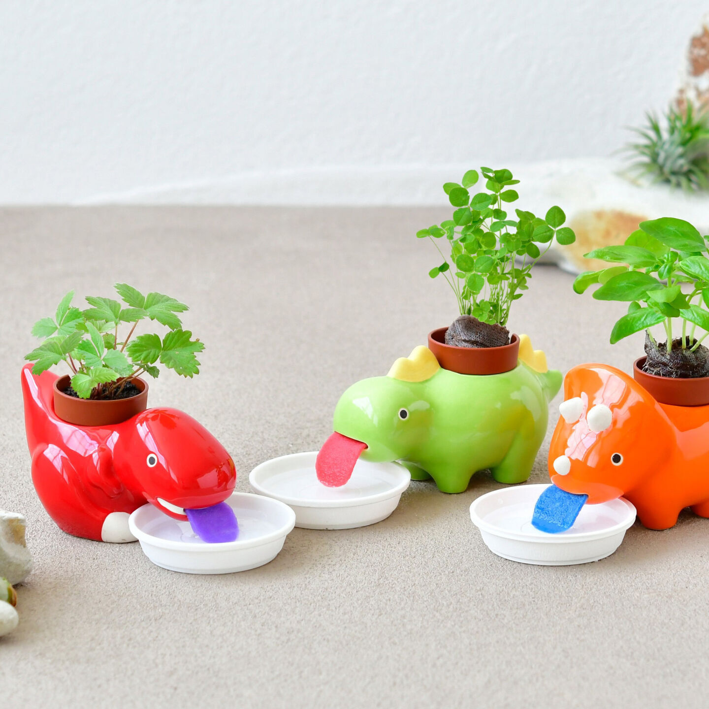 Self-watering dinosaur planters